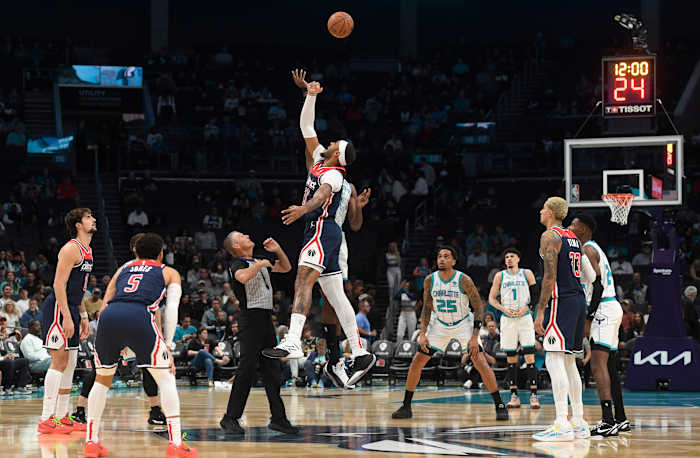 Washington Wizards forward Daniel Gafford (21) and Charlotte Hornets center Mark Williams (5) tip off the game at the Spectrum Center.